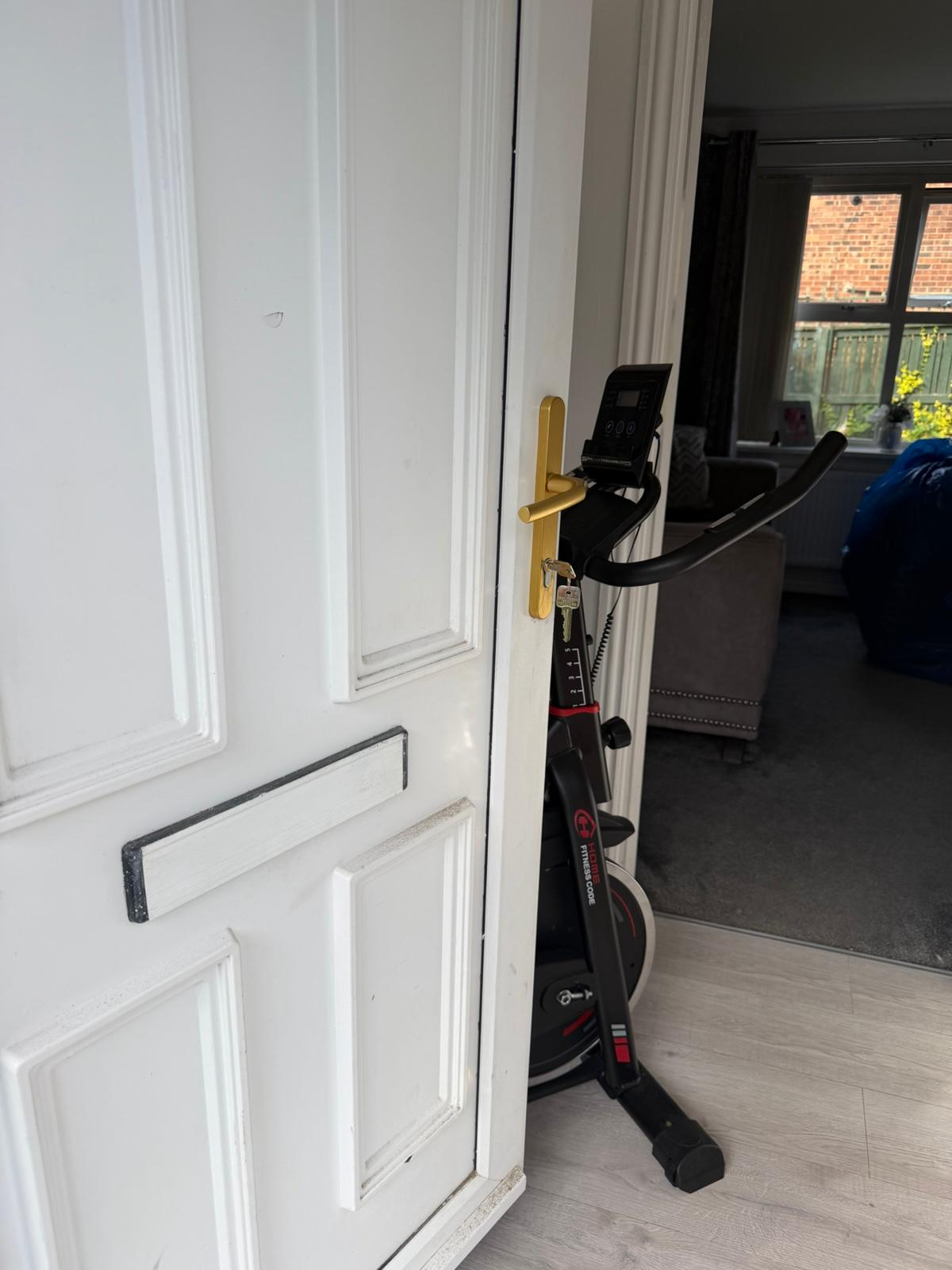White uPVC front door opened with new gold lever handle and freshly cut keys fitted by A Slater & Son locksmith