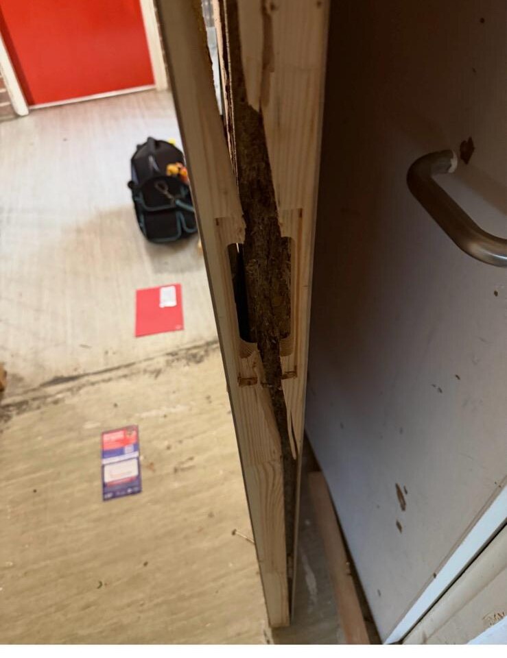 Splintered timber door frame and damaged lock keep after police forced entry on a Teesside housing association property