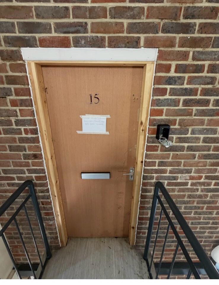 Repaired wooden front door with new timber frame, fresh lock and lever handle fitted by A Slater & Son after police entry